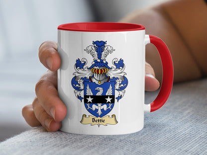 White mug with red handle displaying a coat of arms with the name Bettie.