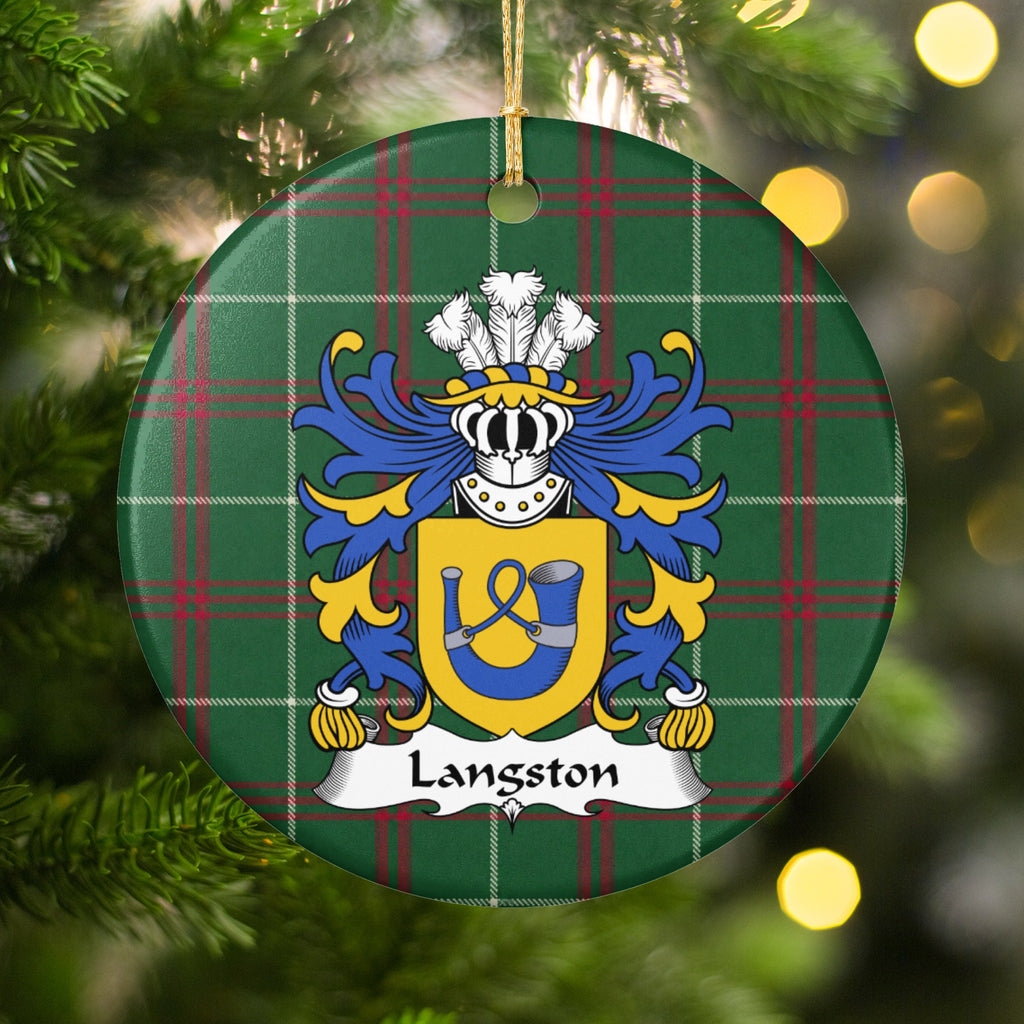 Langston ornament hanging on a Christmas tree among green branches and warm lights, with a gold shield with a blue hunting horn and looped cord on Welsh national tartan.