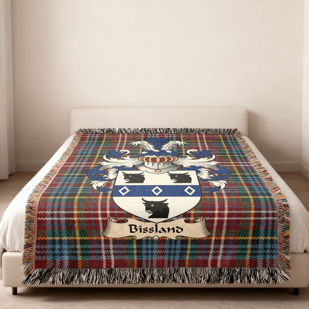Bissland family crest emblem on a Caledonia tartan woven blanket