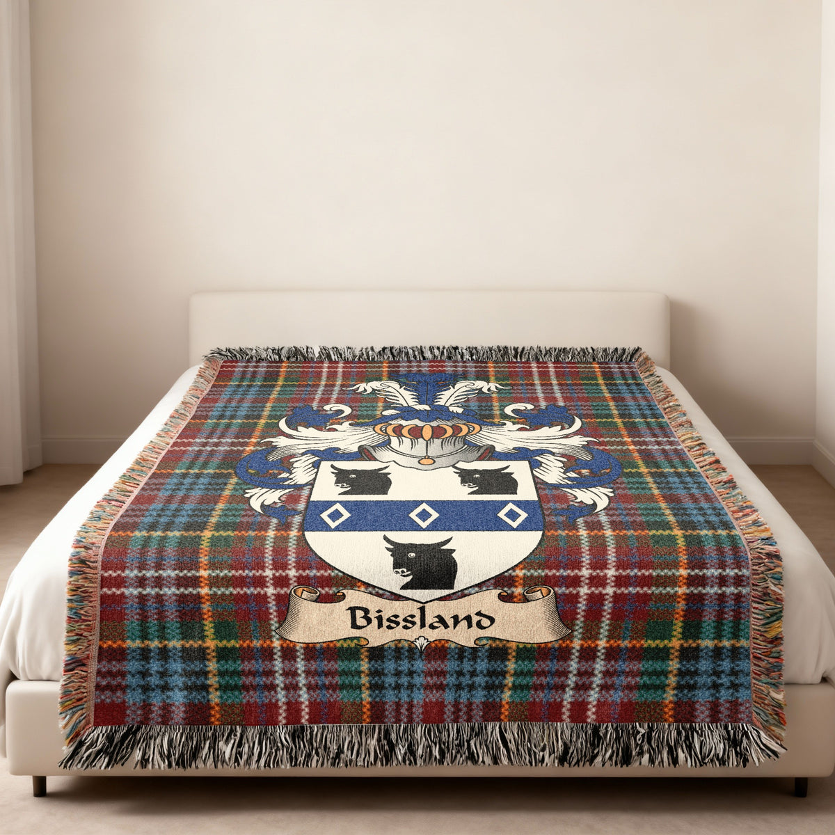Bissland family crest emblem on a Caledonia tartan woven blanket