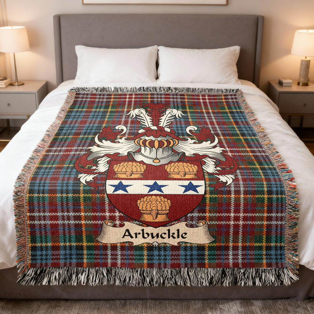 Arbuckle Scottish family crest woven blanket on a Caledonia tartan background, displayed on a bed