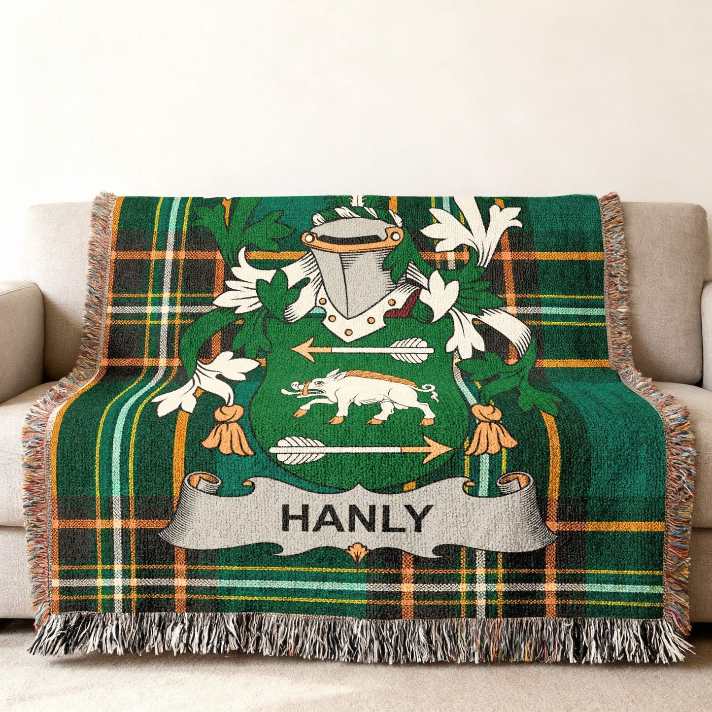 Hanly family crest on a green tartan plaid blanket with fringe.
