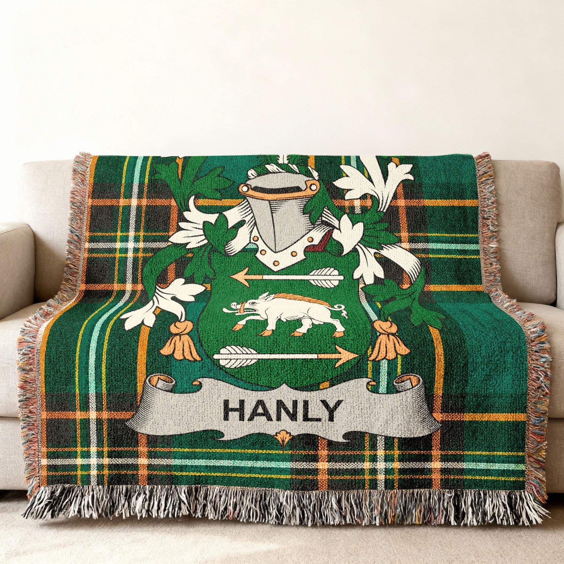 Hanly family crest on a green tartan plaid blanket with fringe.