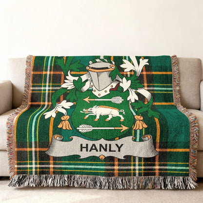 Hanly family crest on a green tartan plaid blanket with fringe.