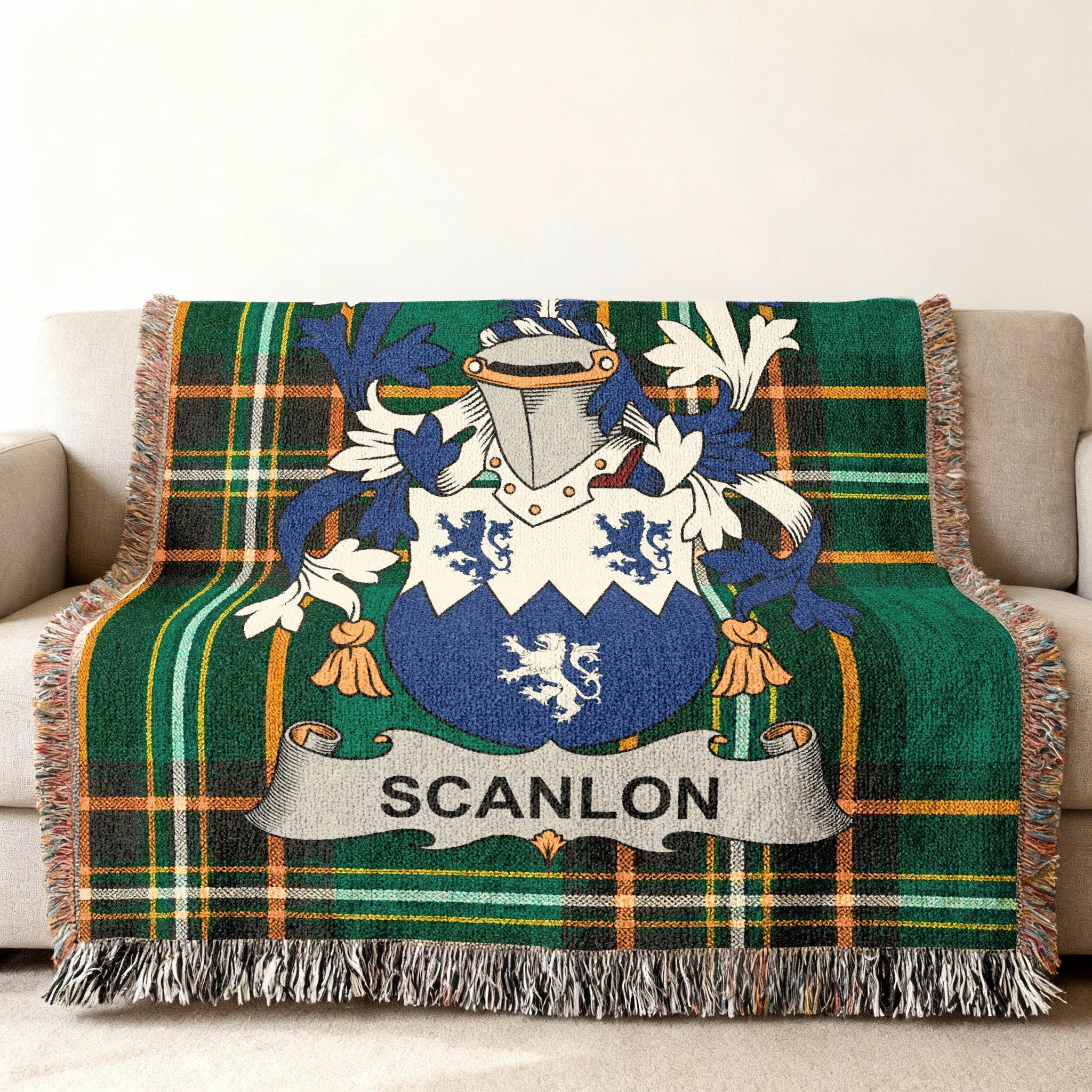 Green tartan blanket with Scanlon family crest draped over a couch.