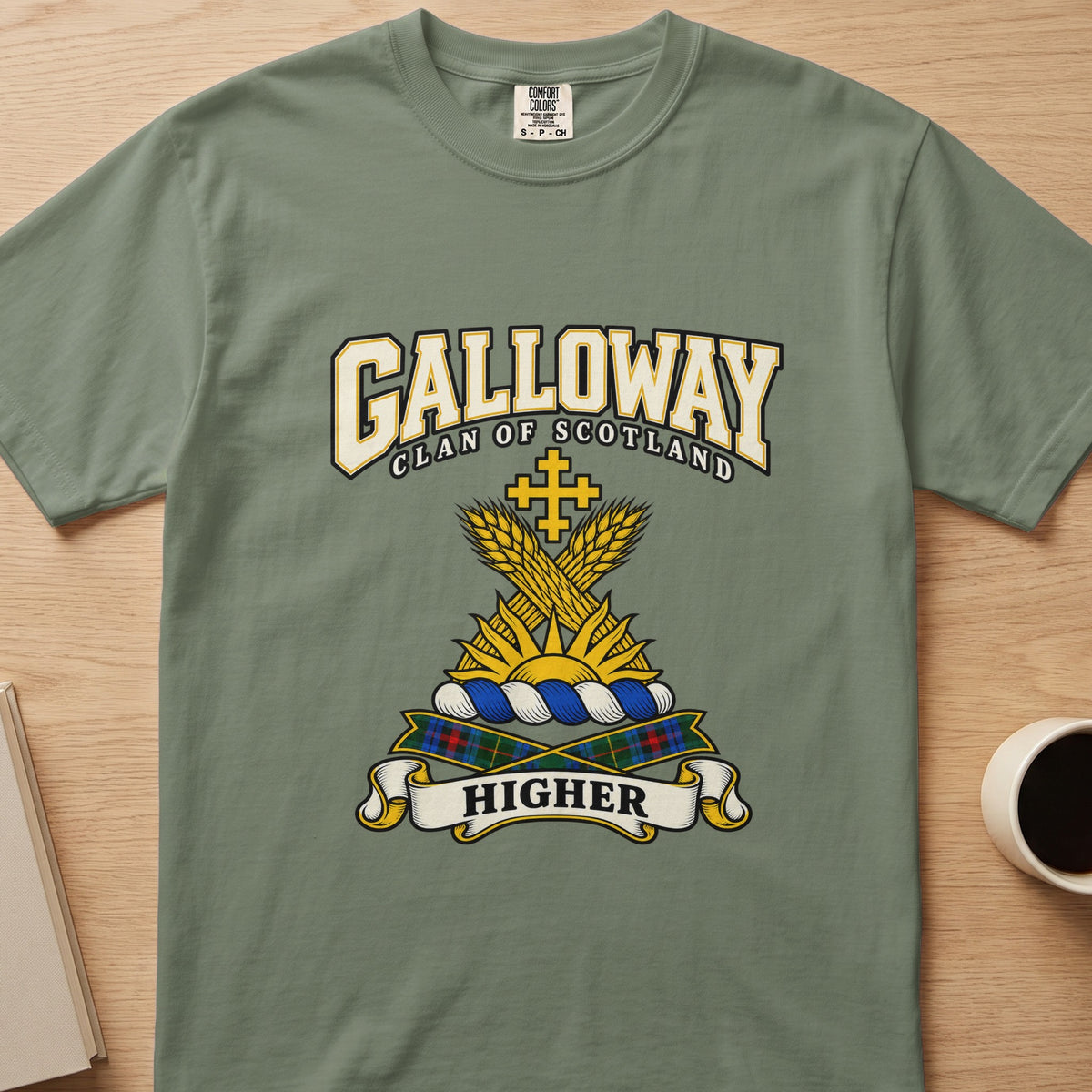 Galloway clan crest with golden wheat and cross on a sage green Comfort Colors T-shirt, front view