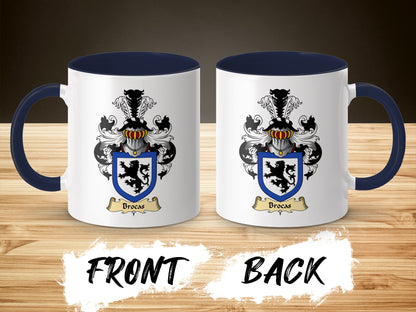 Two white mugs with navy blue handles and rims, displaying a family crest with a lion.