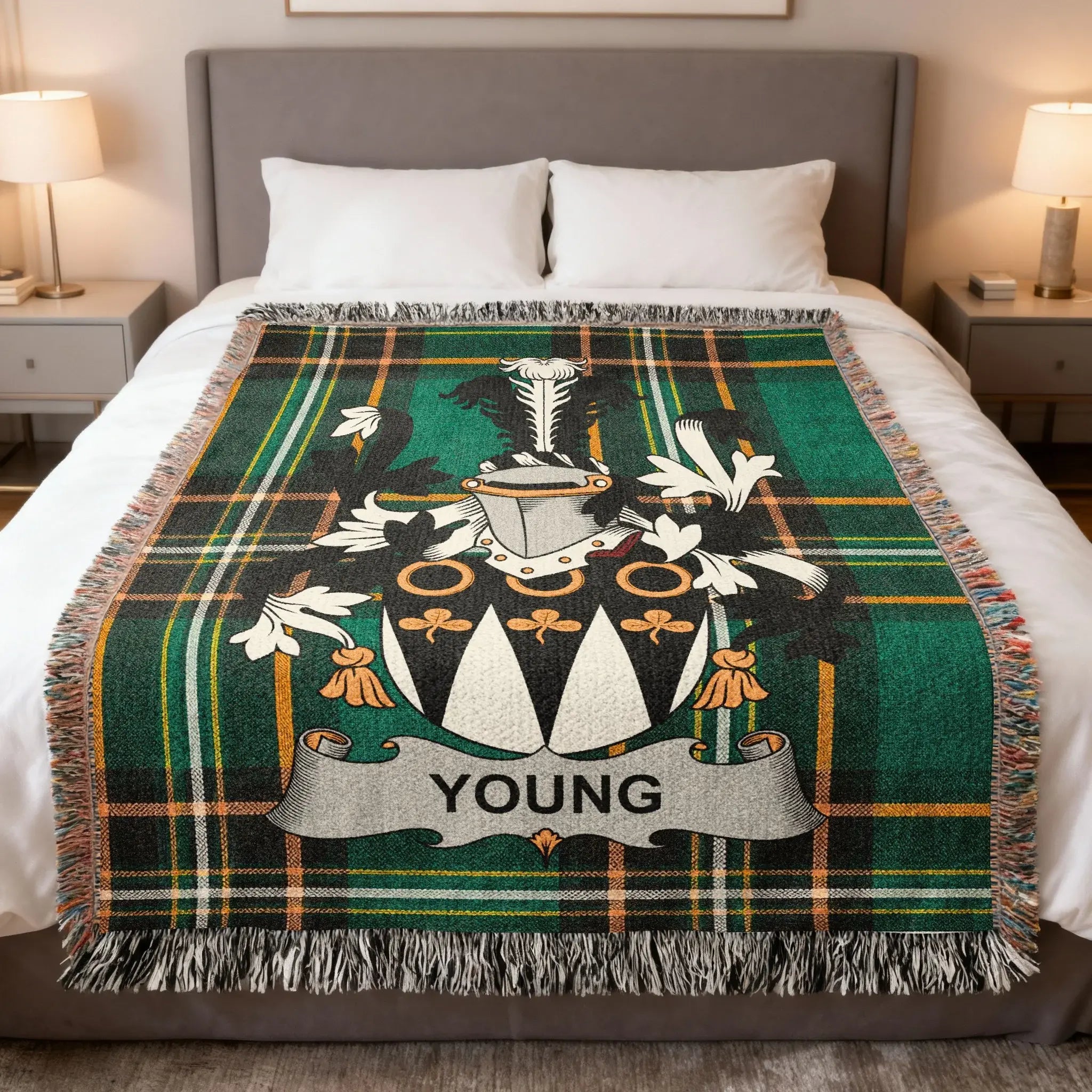 Tartan blanket with coat of arms and "YOUNG" banner on a bed.