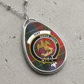 Pendant with tartan pattern, eagle crest, and text "HAY SERVA JUGUM" on chain.