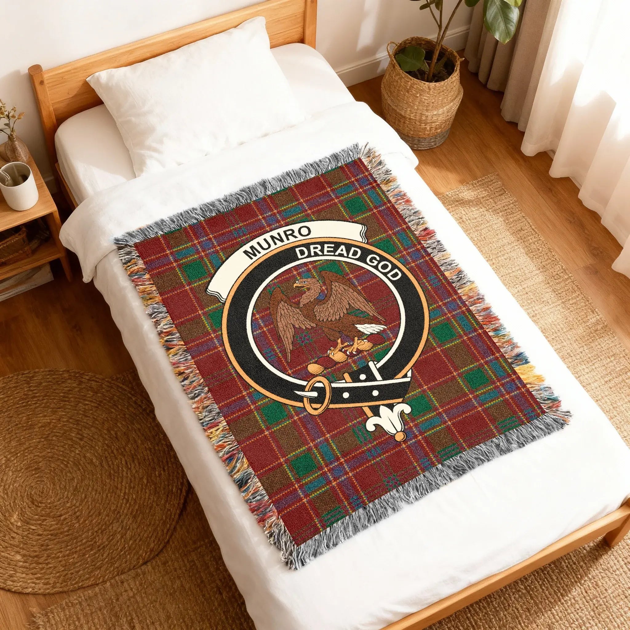 Munro Dread God tartan woven throw blanket on sofa — clan colours in cotton