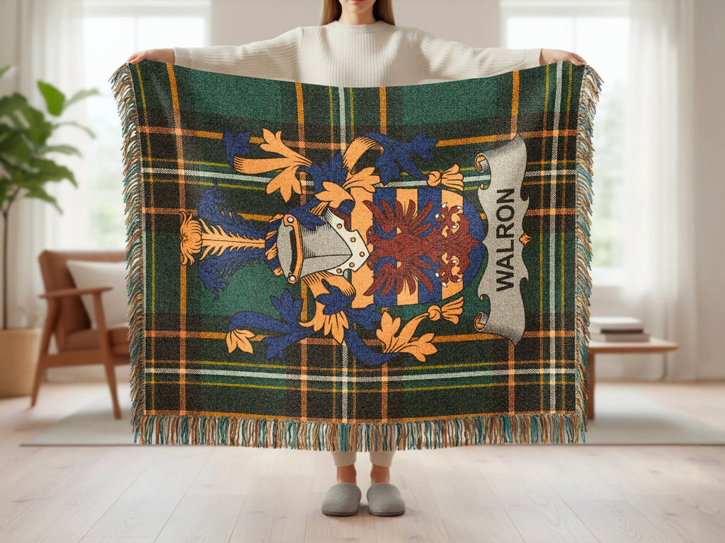 Tartan blanket with crest and "WALRON" text, held by person.