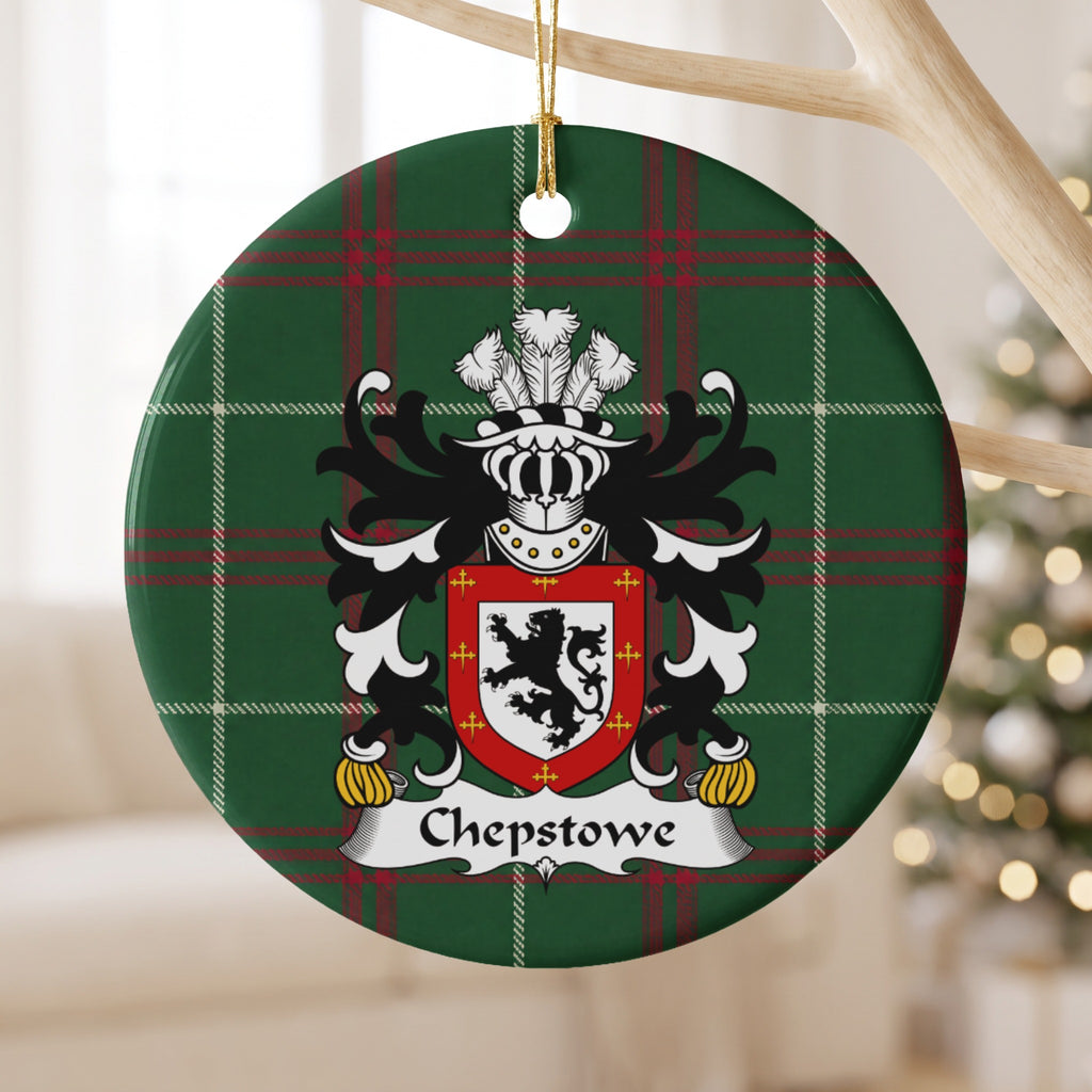 Chepstowe ornament hanging from a pale wooden branch; a black upright lion on white within a red border decorated with small gold crosses on Welsh national tartan.