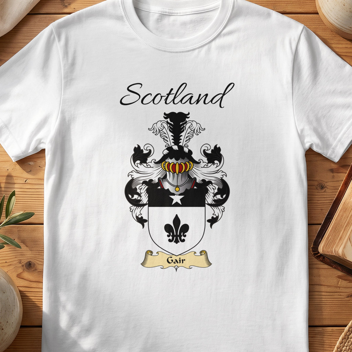 White Gair Scottish family shield T-shirt featuring a black fleur-de-lis on a pale shield