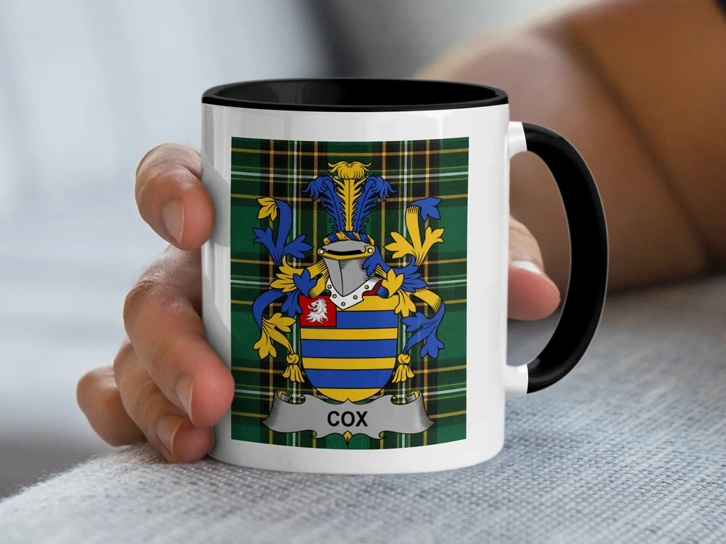 Mug featuring the Cox family crest on a tartan background.