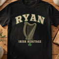Ryan Irish harp T-shirt in Black, with cream surname lettering, a gold-toned harp, green shamrock and “Irish Heritage” text.