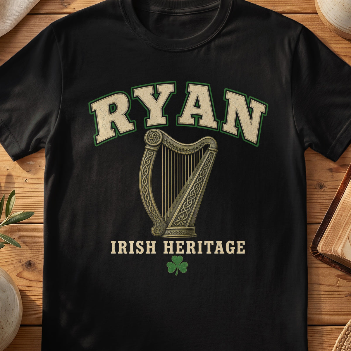 Ryan Irish harp T-shirt in Black, with cream surname lettering, a gold-toned harp, green shamrock and “Irish Heritage” text.