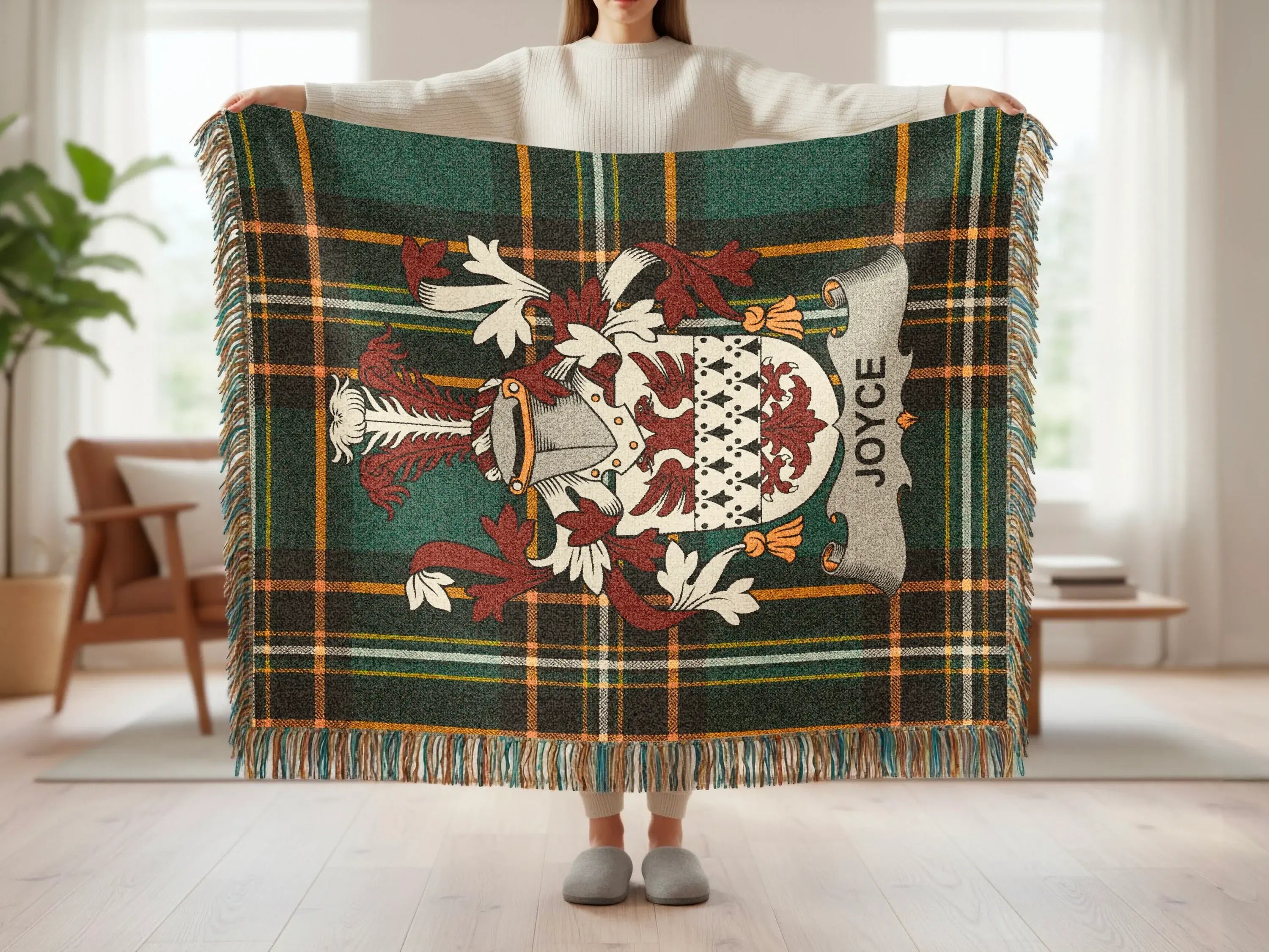 Tartan blanket with family crest for JOYCE, held by person.