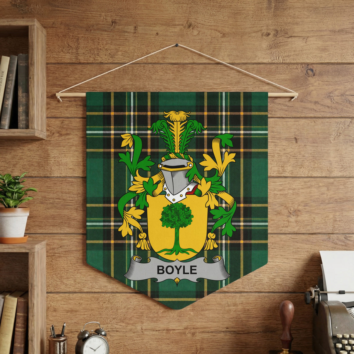 Boyle family crest on green tartan fabric banner hanging on wooden wall.