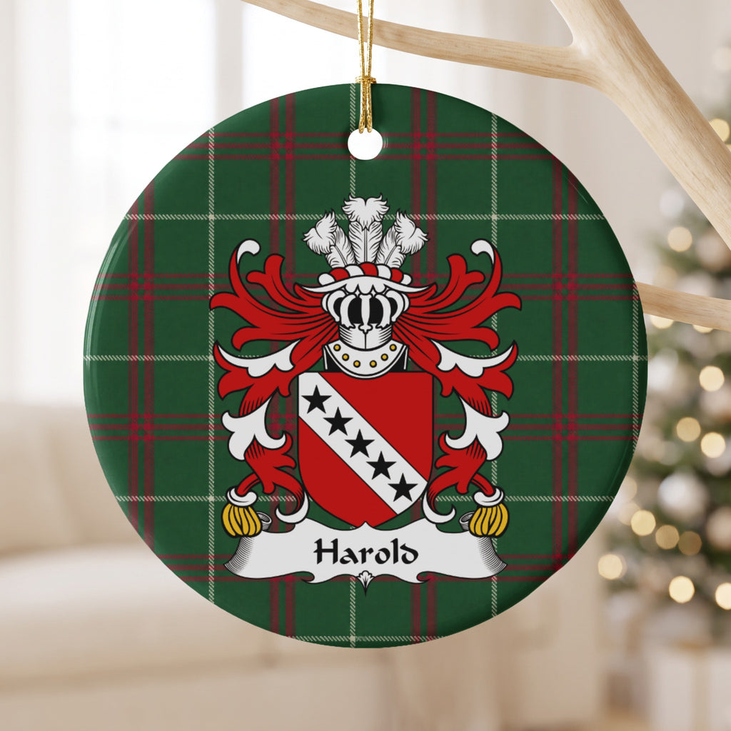 Harold ornament hanging from a pale wooden branch; five black stars on a white diagonal band across a red shield on Welsh national tartan.