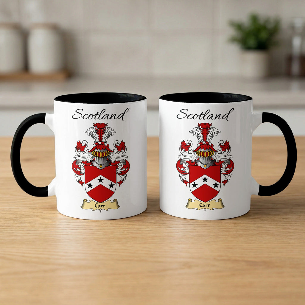 Pair of black-accent Carr mugs showing the double-sided Scottish family shield design on white ceramic.