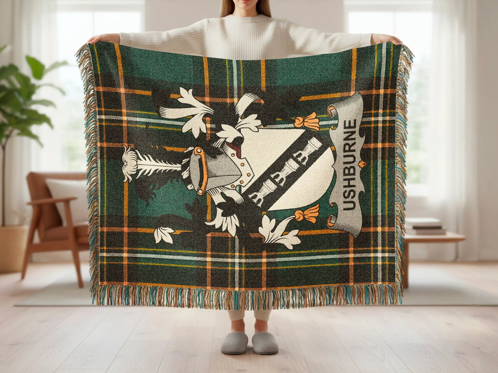 Green and gold tartan throw blanket with Ushburne crest.