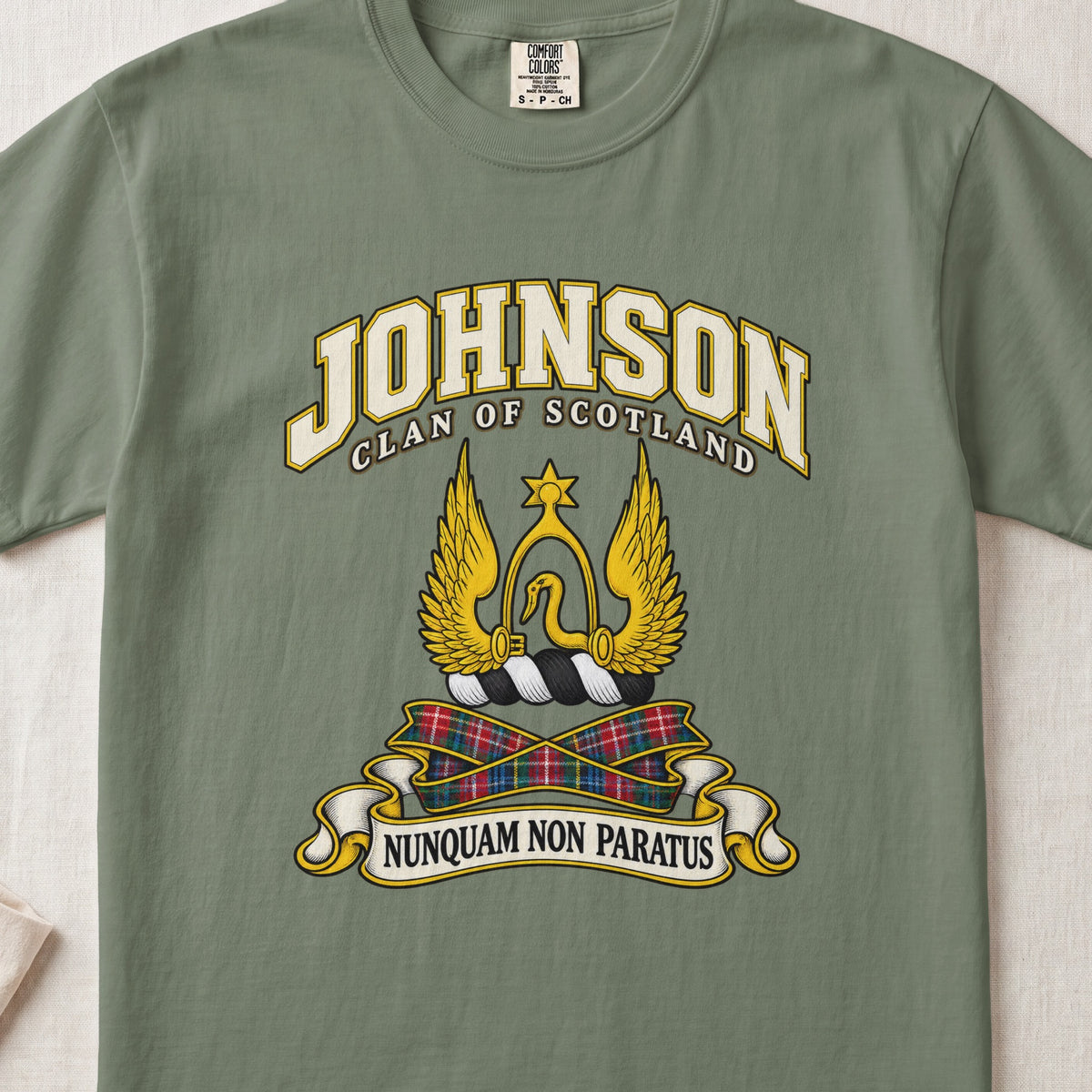 Johnson Scottish clan T-shirt in Moss, front view with a golden winged emblem beneath a star and motto banner.