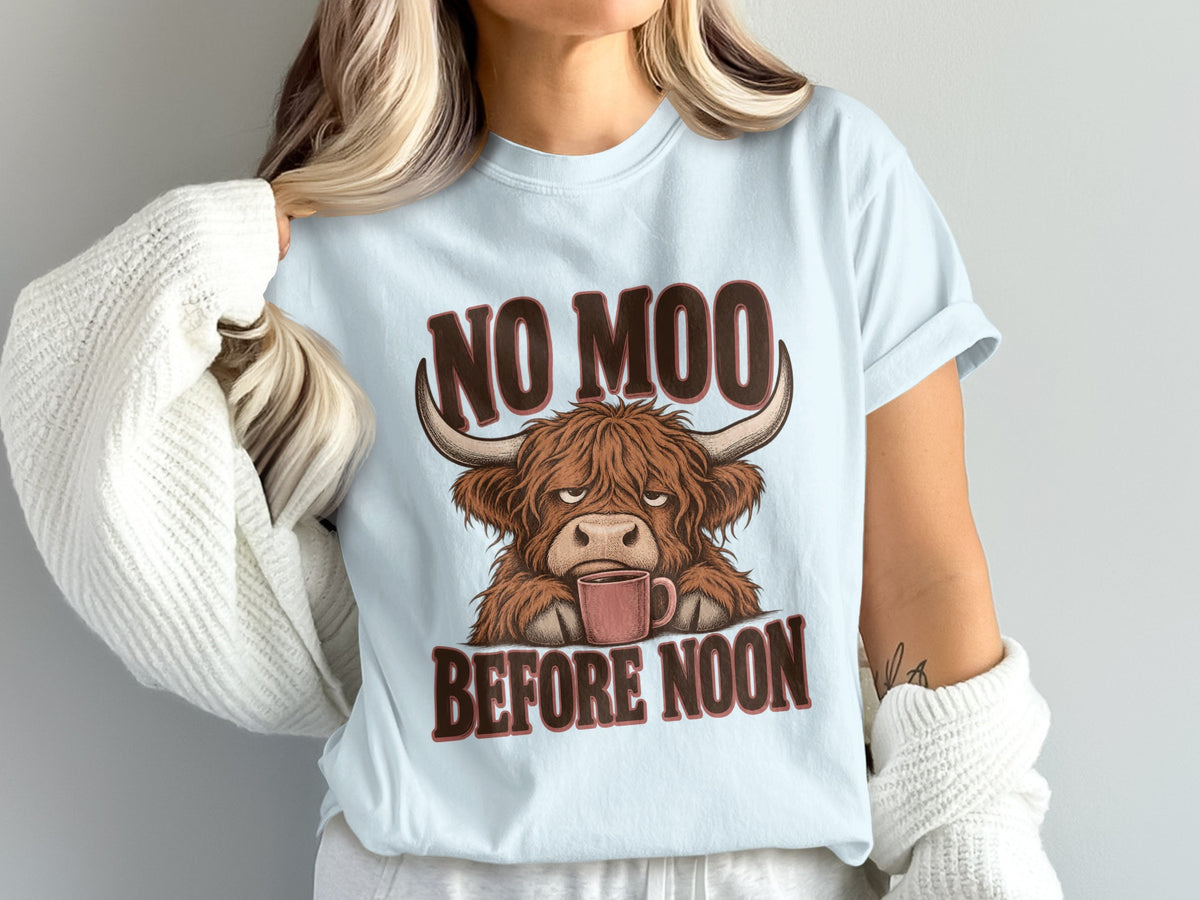 Model wearing the No Moo Before Noon Highland cow Comfort Colors T-shirt in Chambray