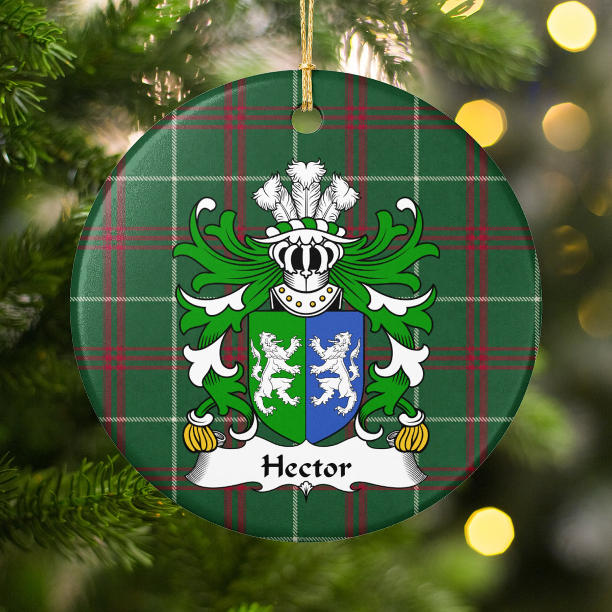 Hector ornament hanging in a Christmas tree with warm lights; two facing white lions on a green-and-blue divided shield on Welsh national tartan.