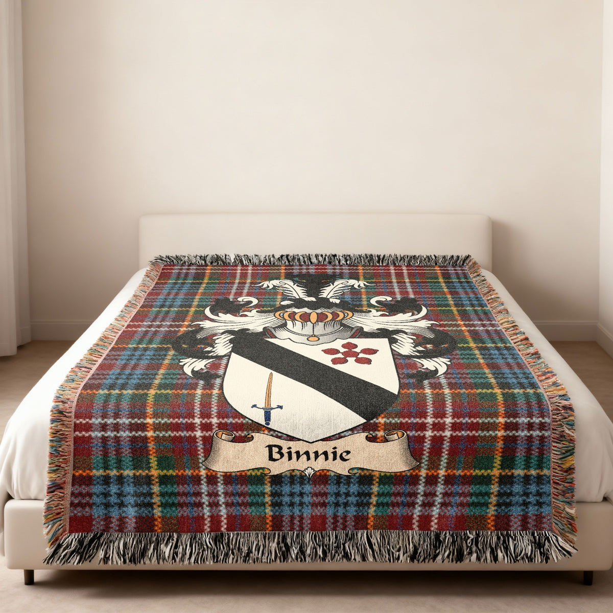 Binnie family crest emblem on a Caledonia tartan woven blanket
