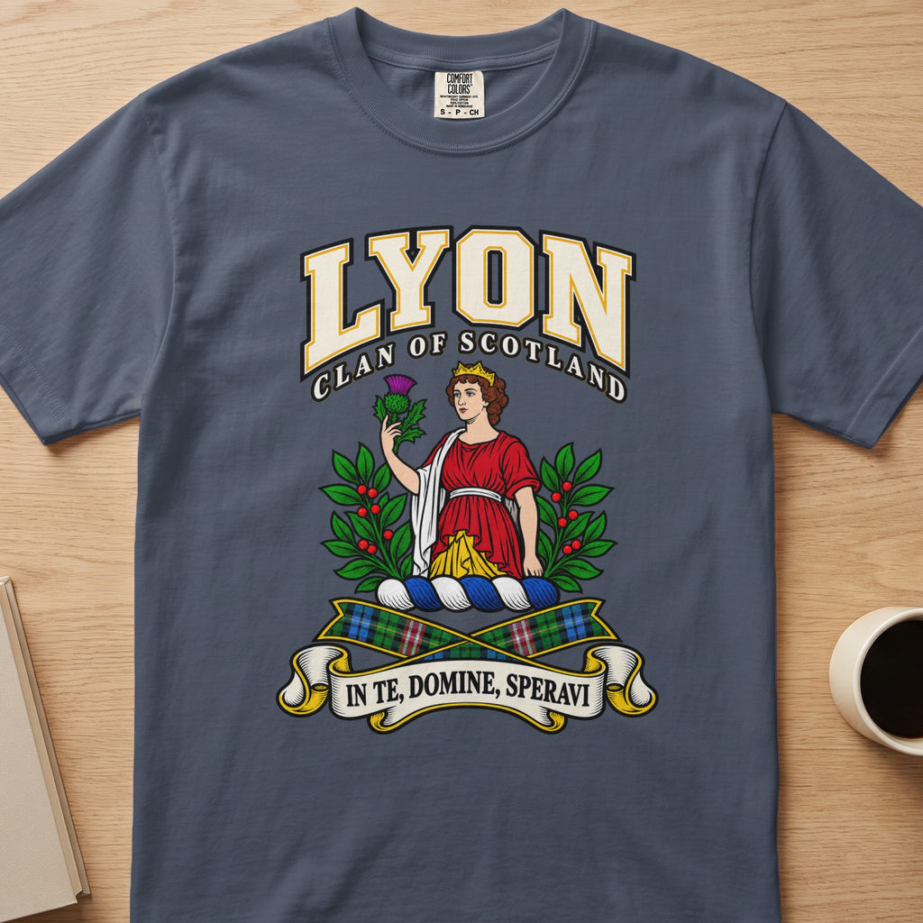 Lyon red-clad figure framed by green branches graphic on a slate blue Comfort Colors T-shirt, front view