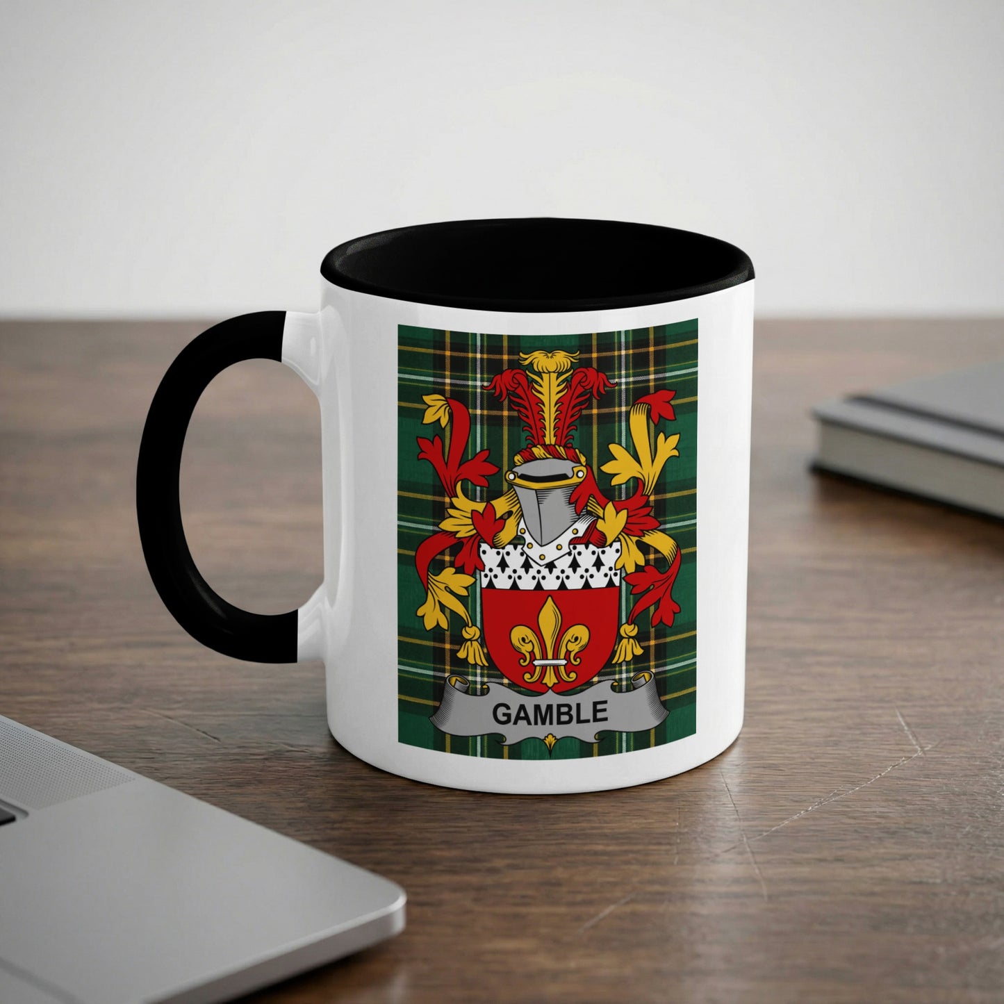 White mug with black rim and handle displaying a coat of arms with the name "GAMBLE".