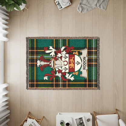 Tapestry with Rodon family crest on green tartan background.