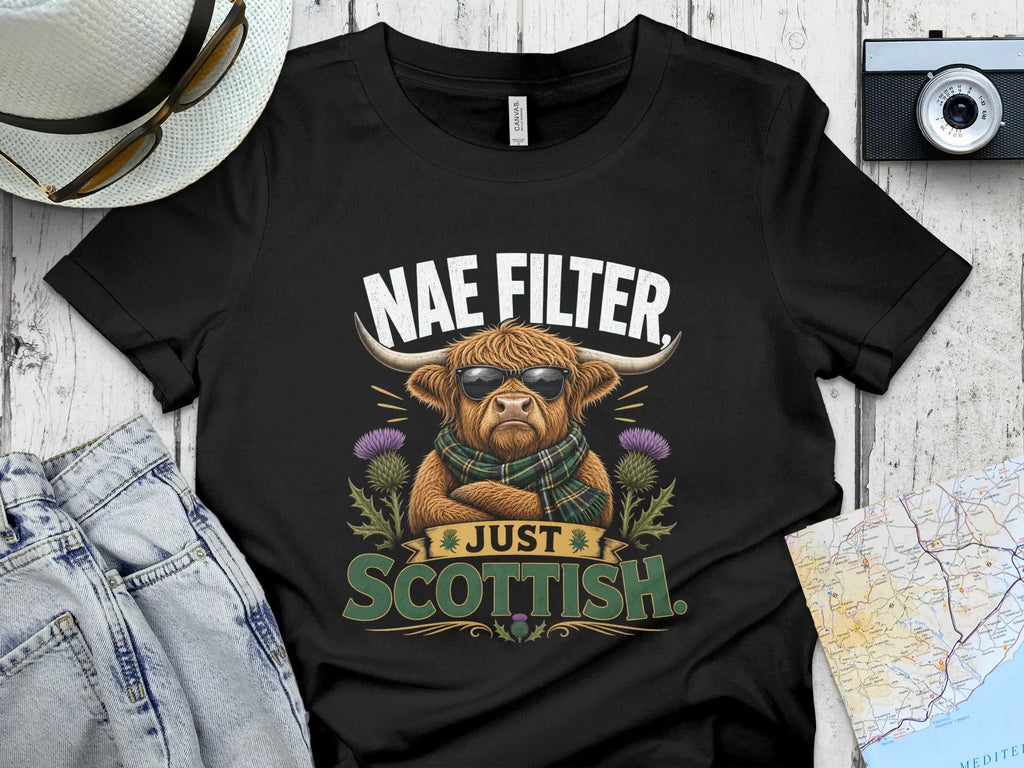 Highland cow with sunglasses wearing a scarf, "Just Scottish" text.