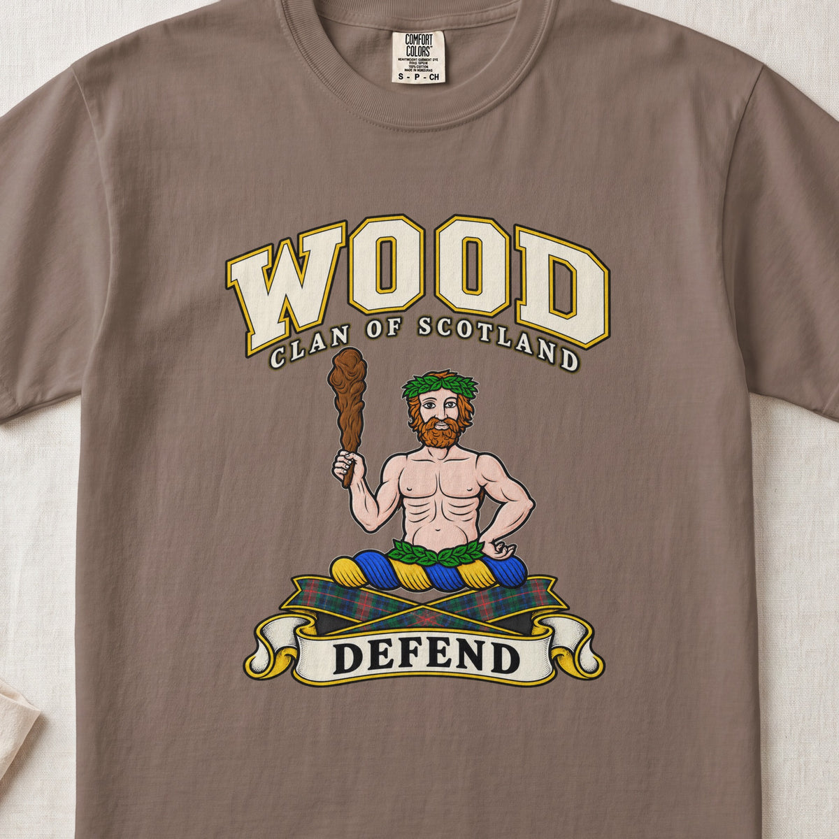 Wood Scottish clan T-shirt in Espresso, front view with a bearded figure holding a wooden club and motto banner.
