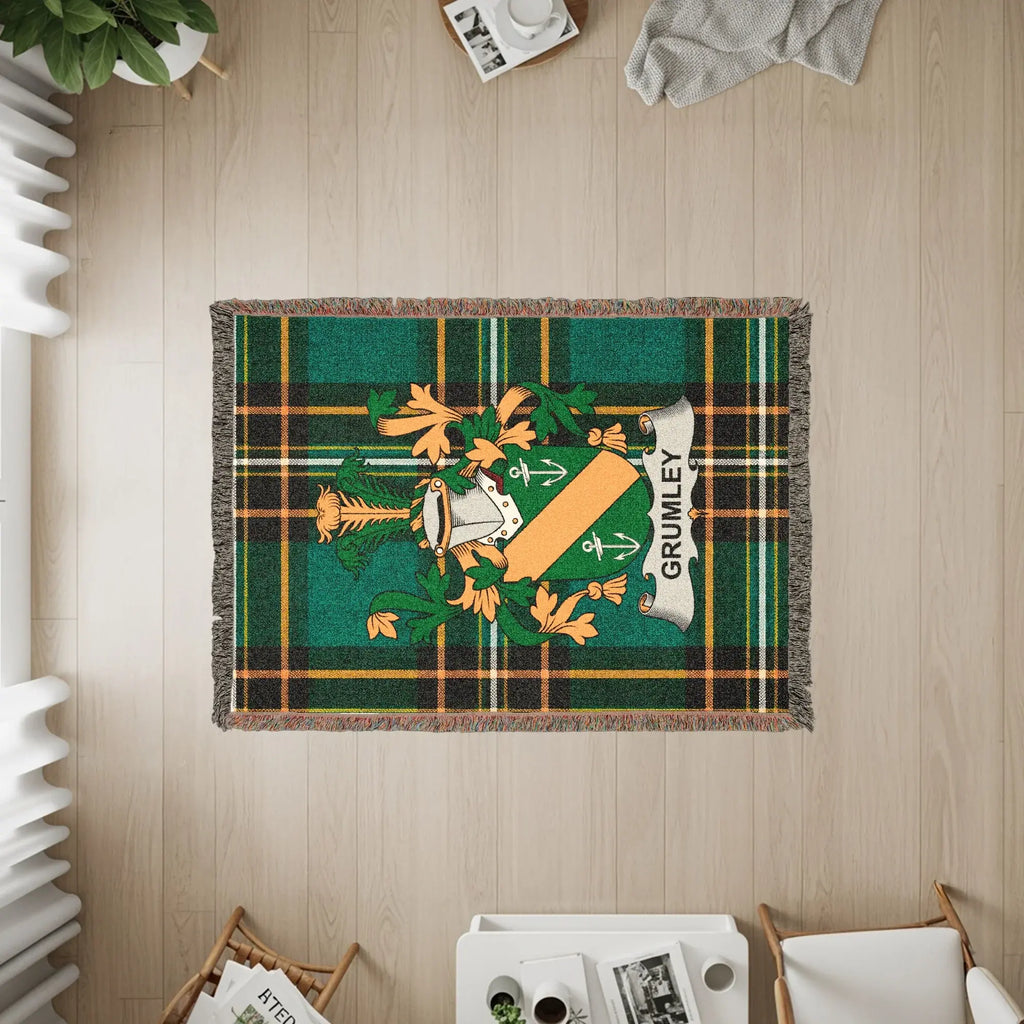 Grumley tartan throw blanket with family crest in green and gold.
