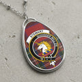 Silver necklace with oval pendant featuring Stewart clan crest and tartan pattern.