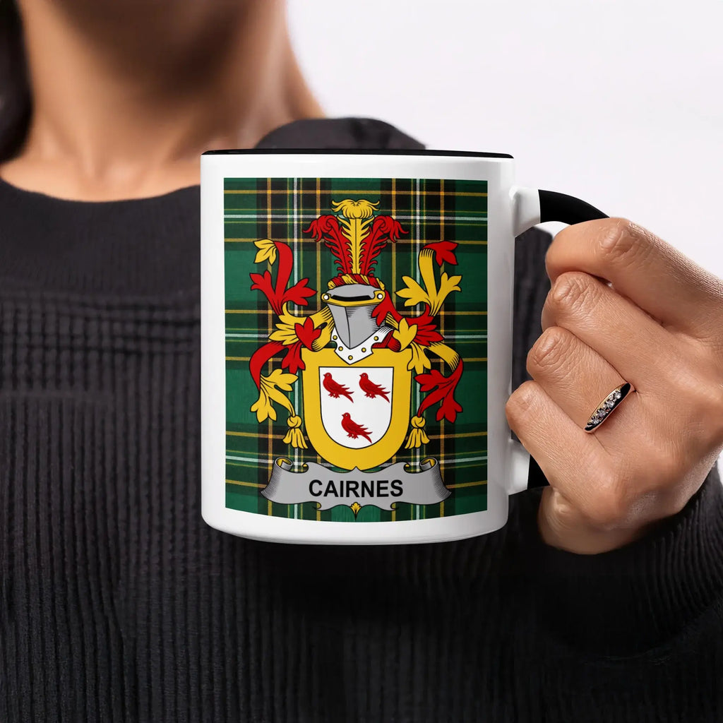 Mug with Cairnes family crest on green plaid background.