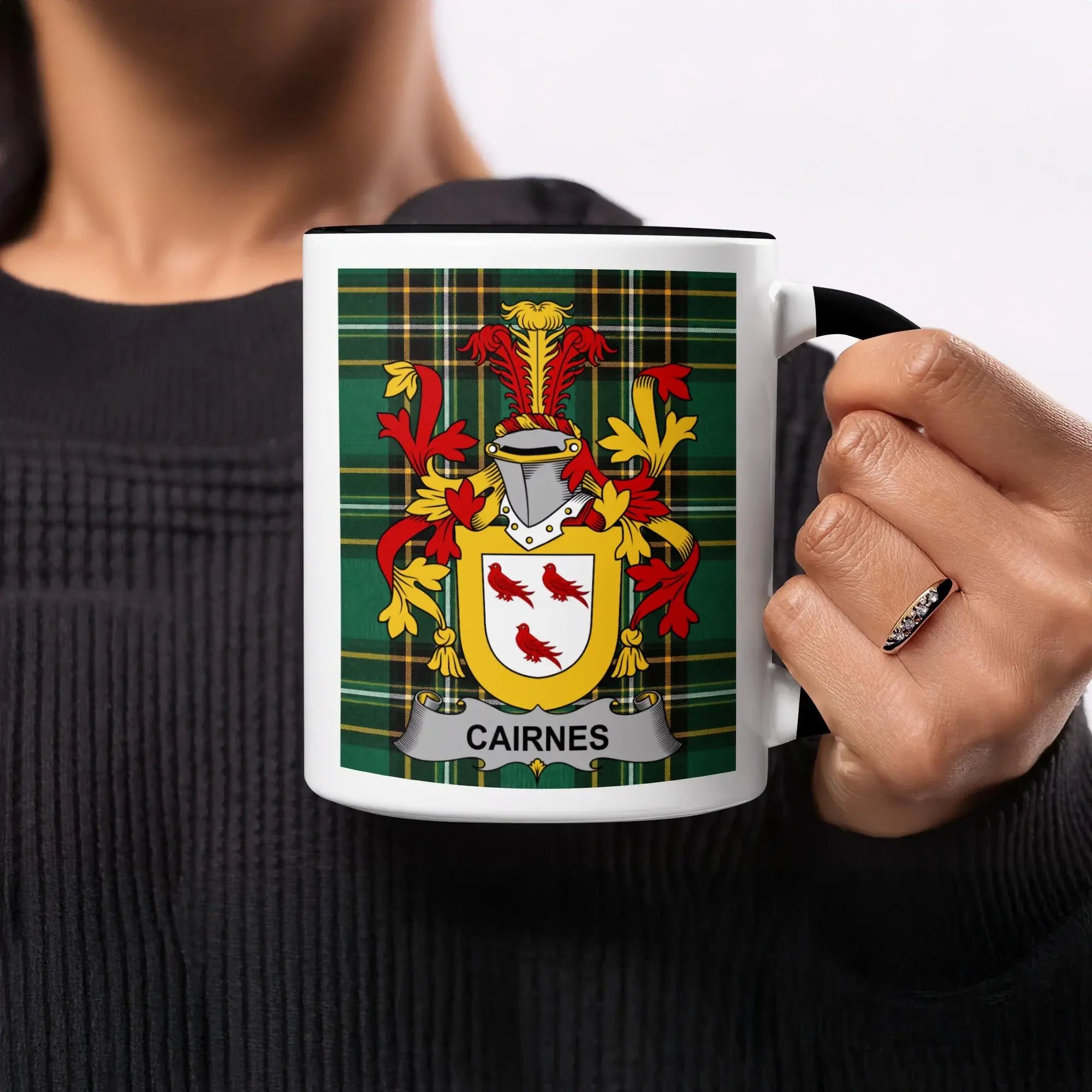 Mug with Cairnes family crest on green plaid background.