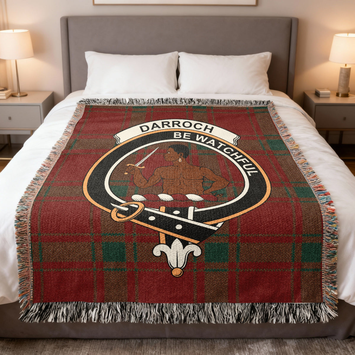 Darroch woven blanket displayed on a bed, with a figure holding a sword on a red and green tartan background