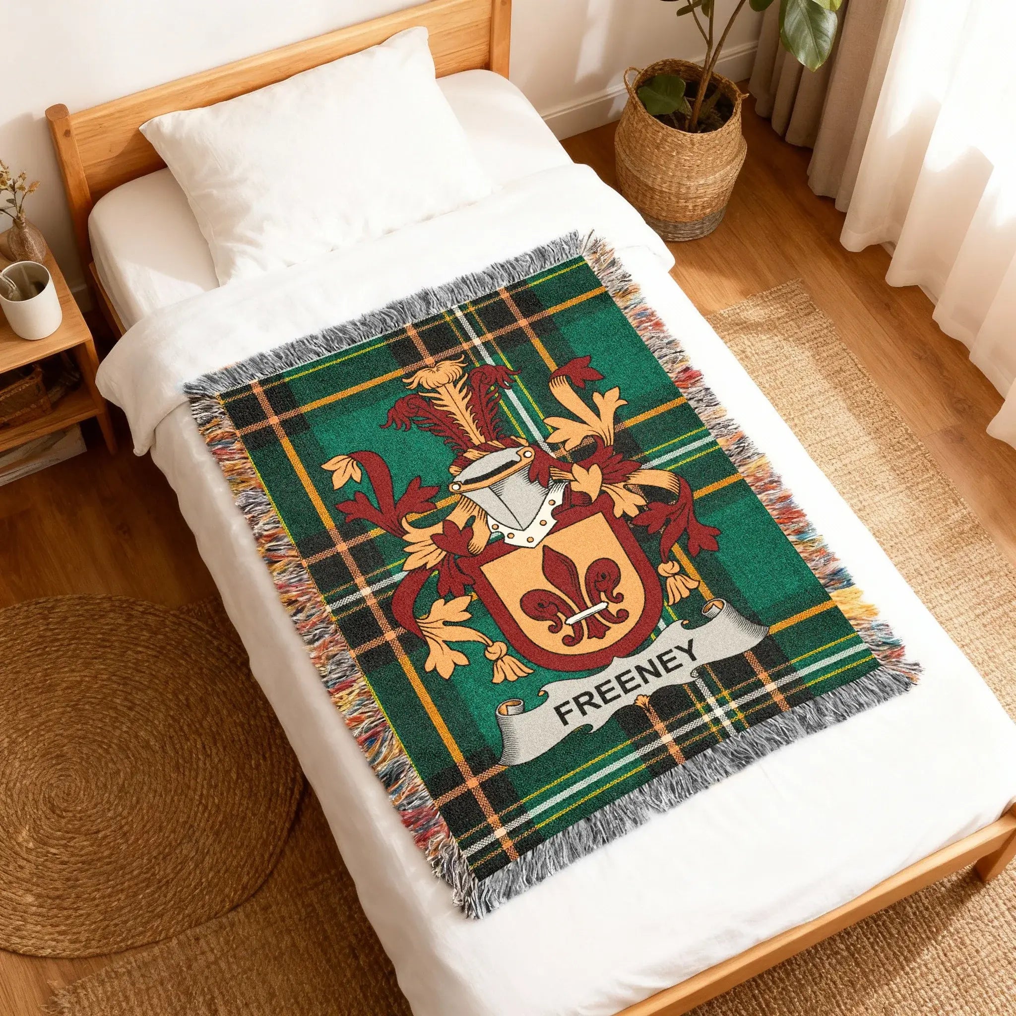 Tartan blanket with Freeney family crest on a bed.