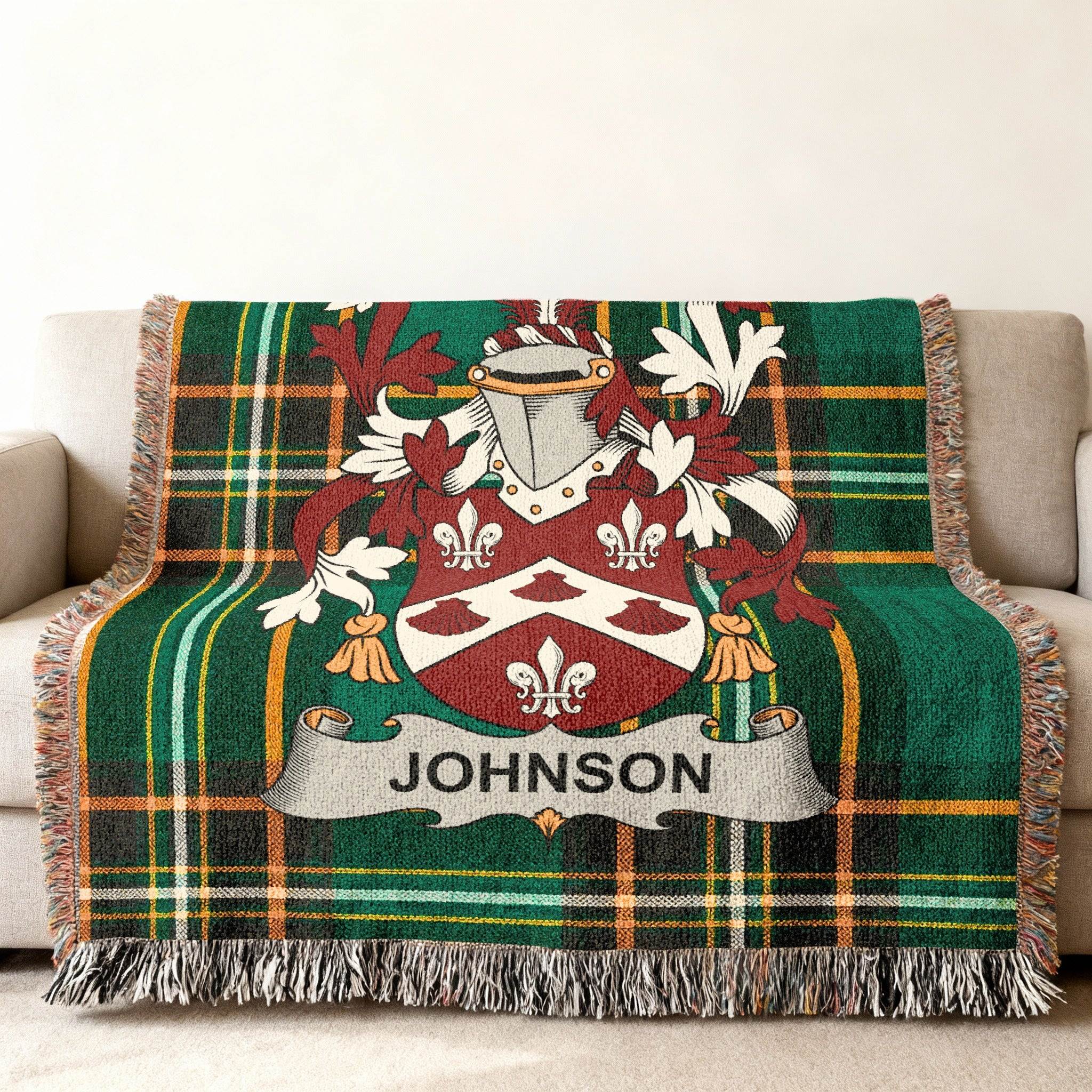 Green plaid throw blanket with a coat of arms and the name Johnson.