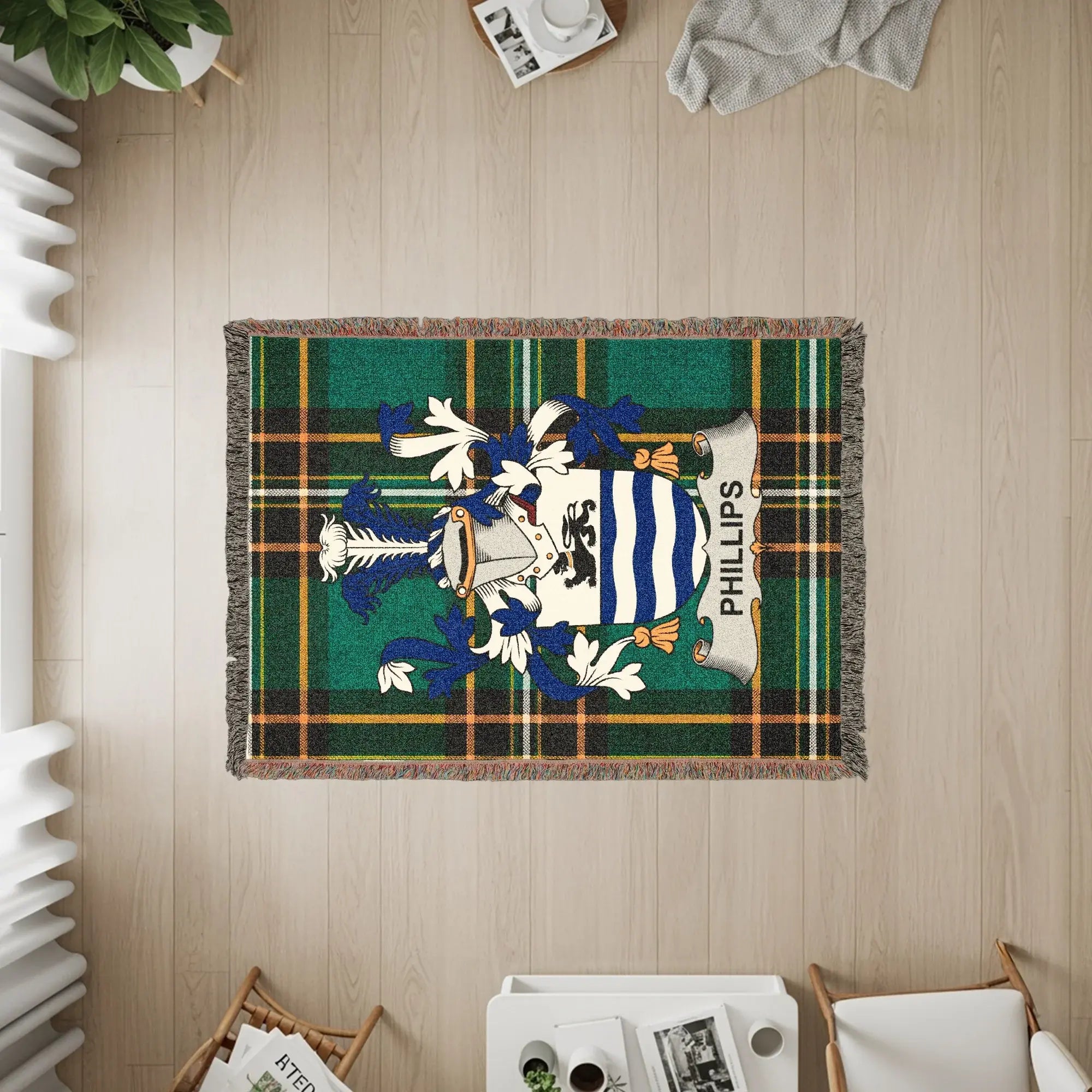Phillips family crest on a woven green plaid throw blanket.