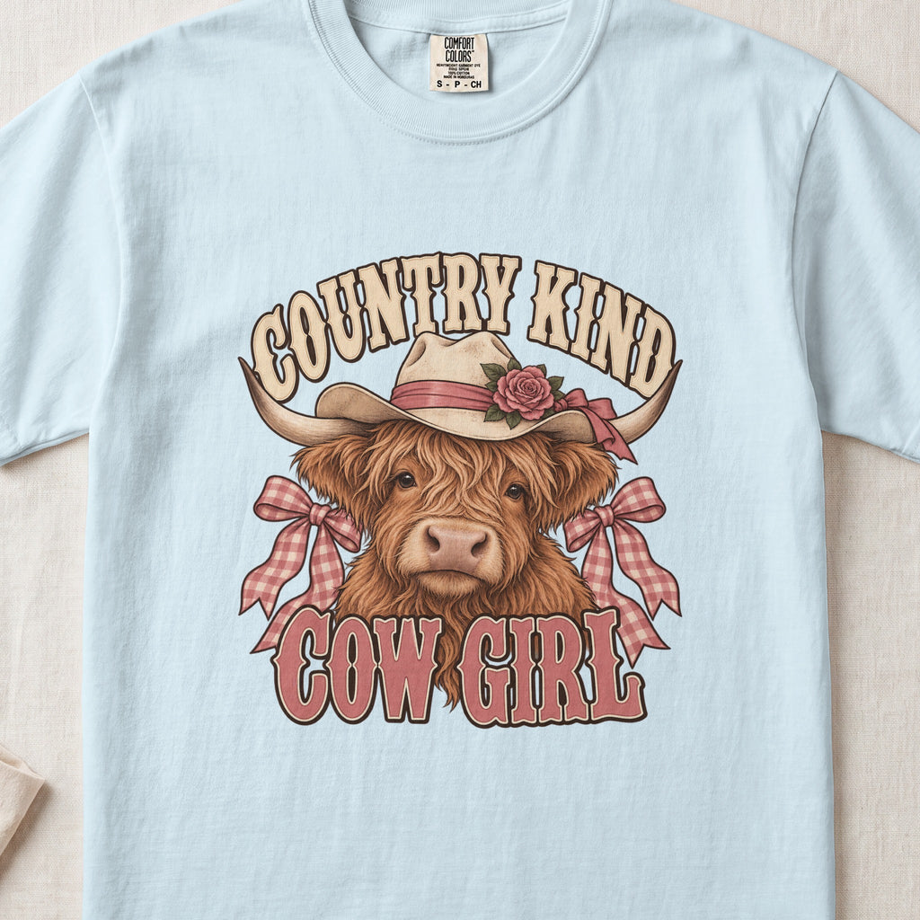 Country Kind Cow Girl Highland cow design on a Chambray Comfort Colors 1717 T-shirt, flat lay