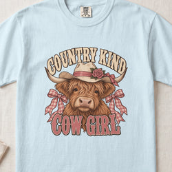 Country Kind Cow Girl Highland cow design on a Chambray Comfort Colors 1717 T-shirt, flat lay