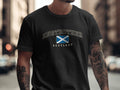 Model wearing the Black Anstruther Scotland Comfort Colors T-shirt with the Scottish Saltire