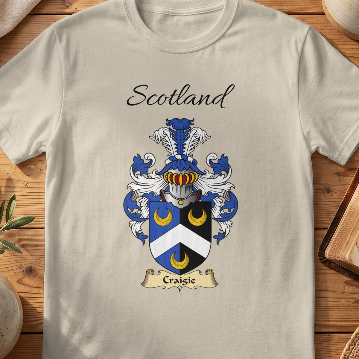 Sand Craigie Scottish family shield T-shirt featuring a white chevron and gold crescents on blue and black