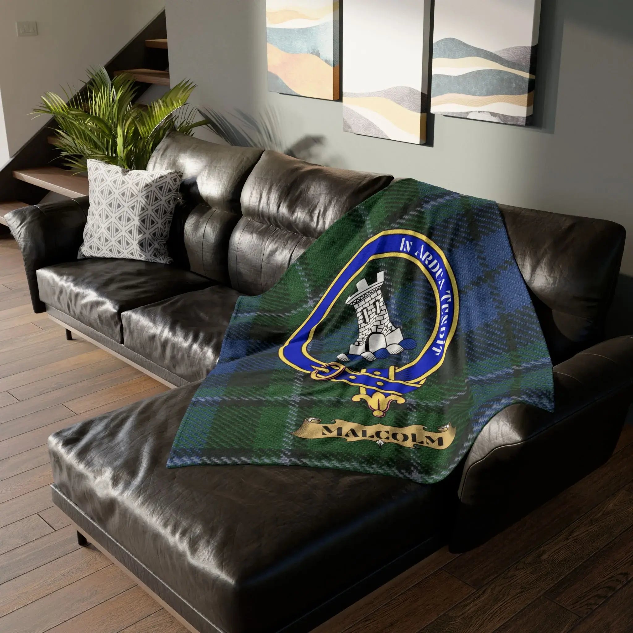 Clan Malcolm blue and green tartan throw blanket with tower crest — draped on leather sofa, 50x60 inch polyester