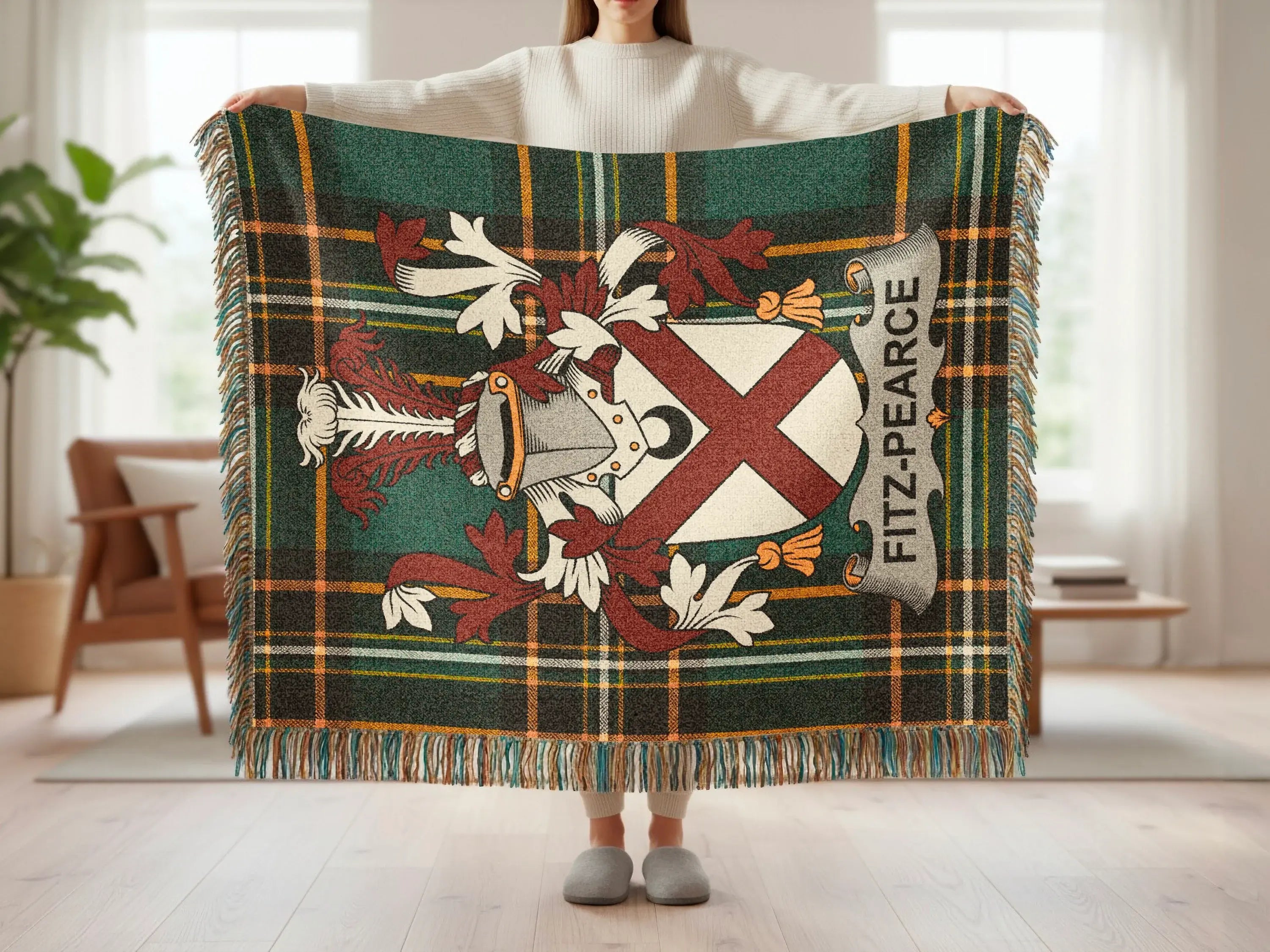 Fitz-Pearce tartan blanket with crest and fringe, held by a person.