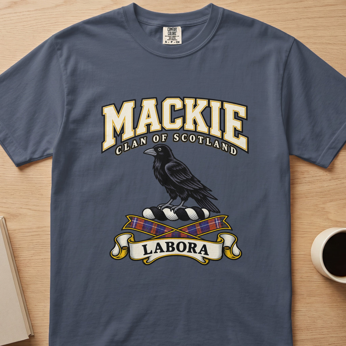 MacKie clan T-shirt in slate blue, front view with black bird above tartan ribbons