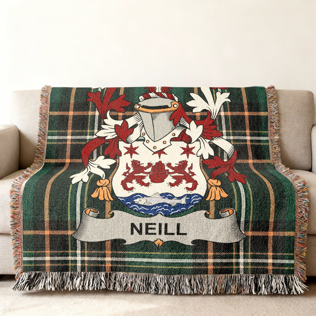 Neill family crest woven blanket on Irish National Tartan displayed on a sofa